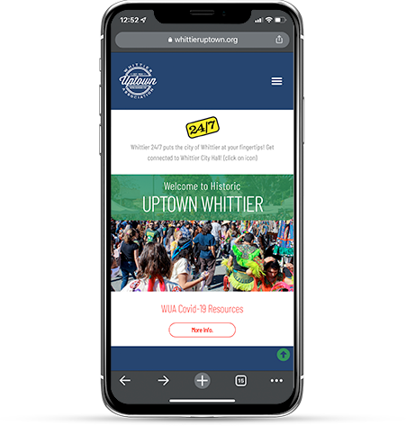 The 2023 site on a phone: the navy header with the Association seal, the Welcome to Historic Uptown Whittier banner, a street fair photograph, and a Covid resources link.